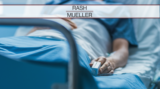 A person lying in a hospital bed.