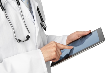 Doctor looking over hip x-rays on tablet